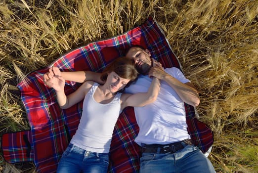 happy young couple in love have romance and fun at wheat field in summer