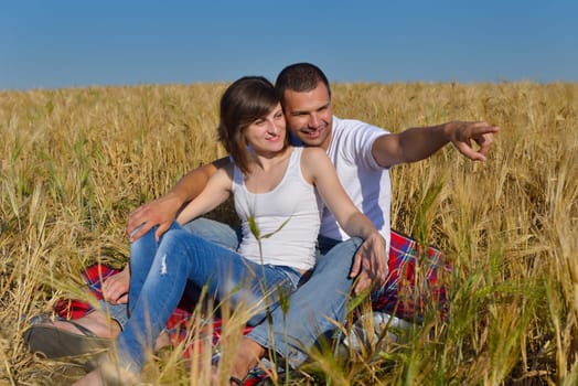 happy young couple in love have romance and fun at wheat field in summer