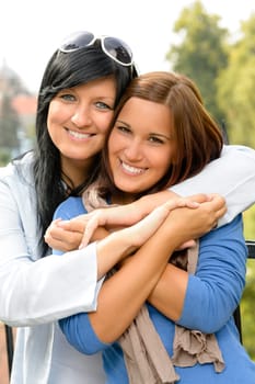 Teen and her mother embracing outdoors bonding daughter happy relaxing