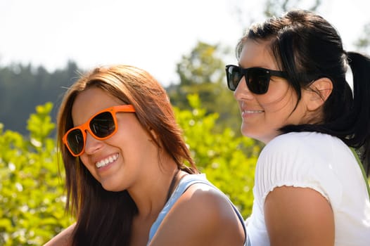 Mother and daughter relaxing in the park teen smiling summer