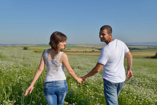happy young couple in love have romance and fun at wheat field in summer