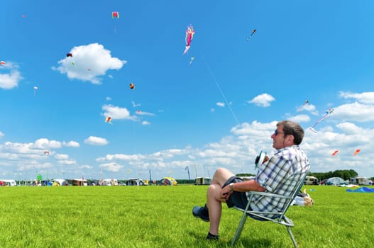 Man holding his kite at the 3rd international kite festival in Twenterand, Netherlands with a lot of participants from Germany and Belgium.