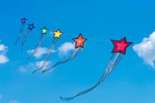 string of colorful star kites during the 3rd international kite festival in Twenterand, Netherlands