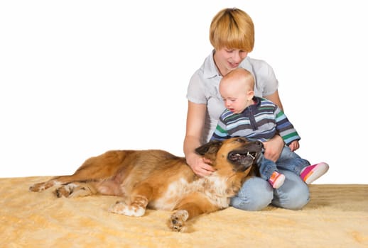 Devoted Mum, small baby and family dog sitting on the floor close together sharing a moment of love and tenderness with copyspace