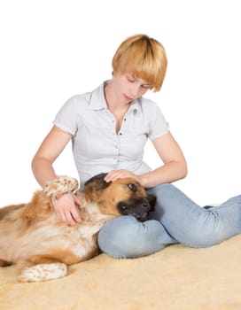 Loving woman with her large gentle crossbreed dog lying with its head on her lap stroking it