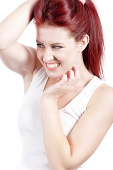 Attractive woman in white vest top holding her red hair up.