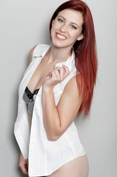 Sexy young woman in shirt and underwear having fun in a beauty style pose