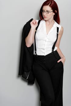 Beautiful young woman in smart business clothes in fashion style pose