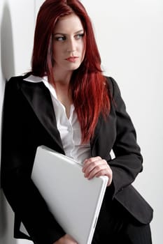 Professional business woman holding a white laptop at work