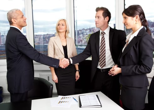 Business handshake over the deal at office