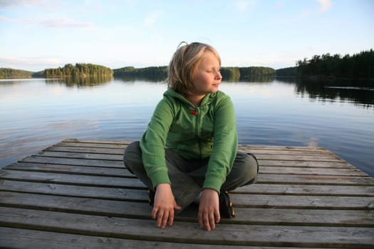 Boy sunbathing by the lake