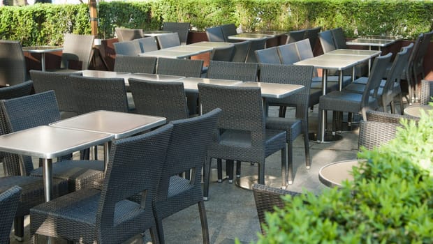 Empty little tables of street cafe a close up