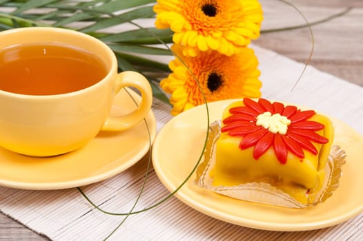 tea with cake and gerberas flowers