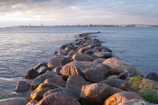 Pier from stones on a sunset