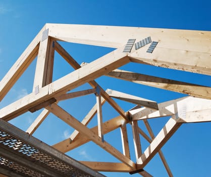 Wooden rafters against the blue sky