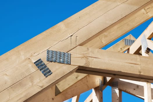 Wooden rafters against the blue sky