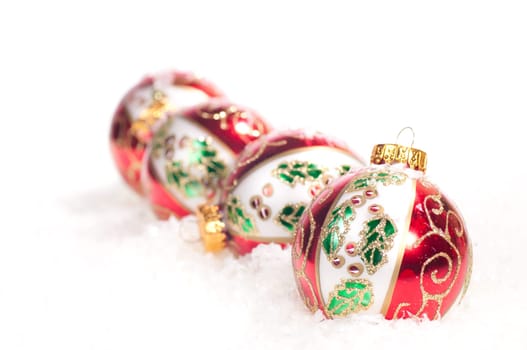 Colourful hand painted glass baubles on snow