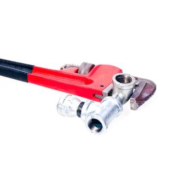 Pipe wrench fixing a tap joint - concept : plumbing
