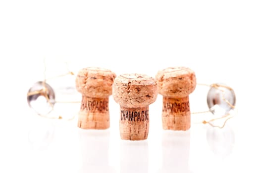 Three Champagne corks close up on white