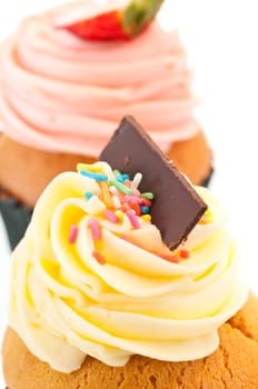 Vanilla cupcake topping vertical close up over white