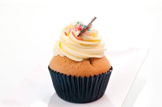 Vanilla cupcake close up on a white plate