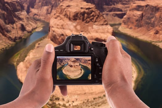 Photographer taking pictures of the Horseshoe bend of Colorado river in Page Arizona - USA