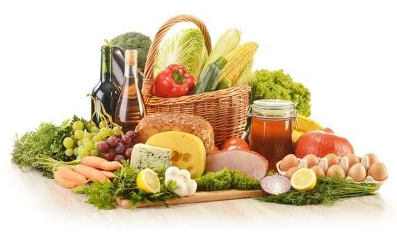 Composition with groceries in wicker basket on kitchen table