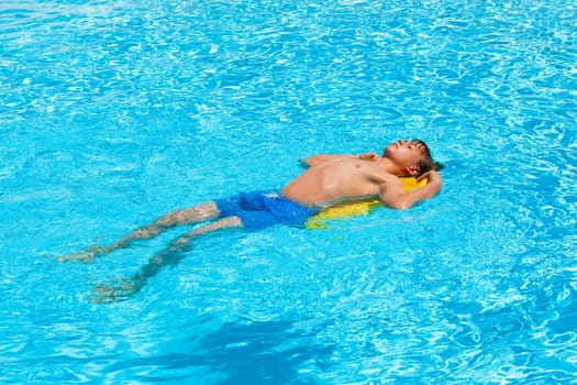 cute boy swimming in the pool