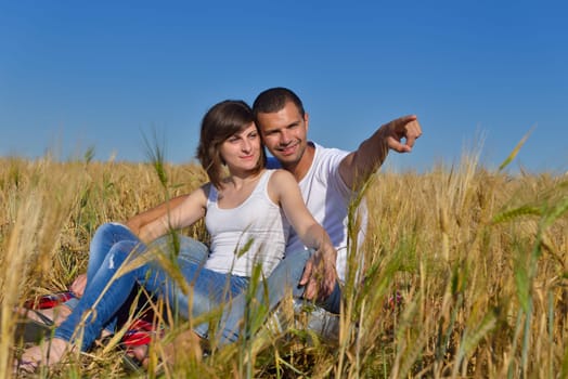 happy young couple in love have romance and fun at wheat field in summer