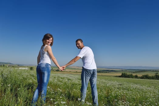 happy young couple in love have romance and fun at wheat field in summer