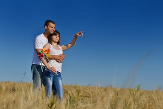 happy young couple in love have romance and fun at wheat field in summer