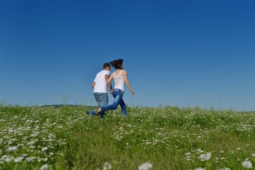 happy young couple in love have romance and fun at wheat field in summer