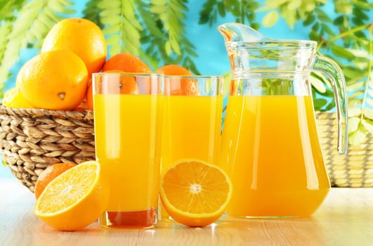 Composition with two glasses of orange juice and fruits