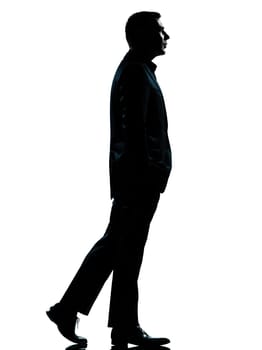 one caucasian business man walking silhouette Full length in studio isolated on white background