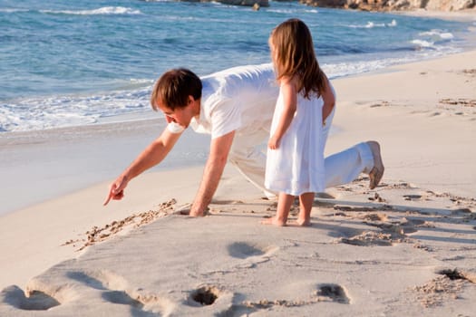 Cheerful family father with little daughter on vacation at the beach in summer