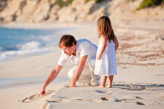 Cheerful family father with little daughter on vacation at the beach in summer