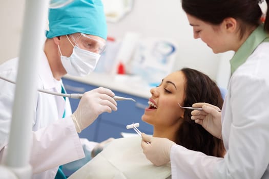 Pretty patient undergoing a dental check