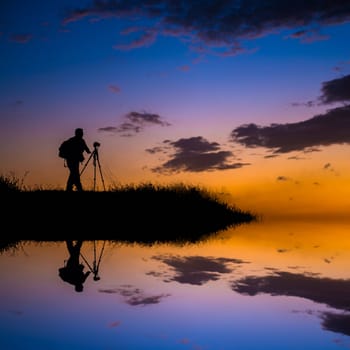 Dream place for photo take, the person is mirrored below with a soft pastel sunset sky as backdrop