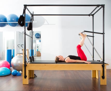 Pilates aerobic instructor woman in cadillac fitness exercise