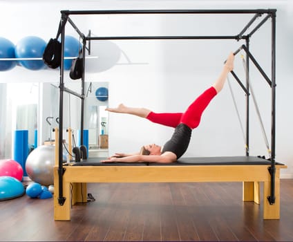 Aerobics pilates instructor woman in cadillac fitness exercise