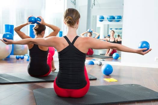 Pilates toning ball in women fitness class rear mirror view