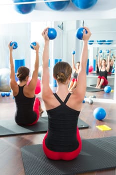 Pilates toning ball in women fitness class rear mirror view