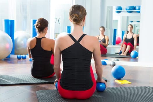 Pilates toning ball in women fitness class rear mirror view