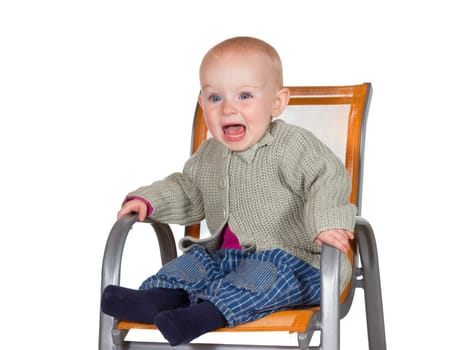 Distressed tearful baby with its mouth wide open in anguish sitting alone in a childs highchair