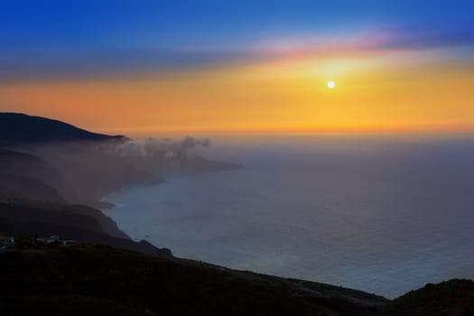 La Palma muntains sunset with orange sun in canary islands