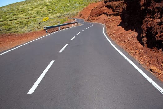 Canary Islands winding road curves in red mountain