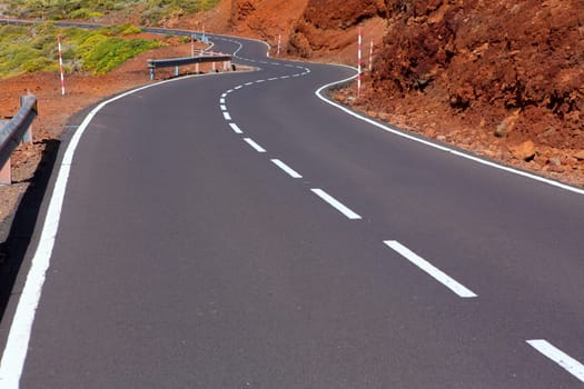 Canary Islands winding road curves in red mountain