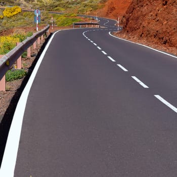 Canary Islands winding road curves in red mountain