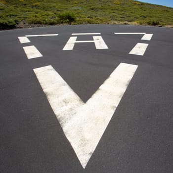 heliport triangle white soil painted sign in pavement