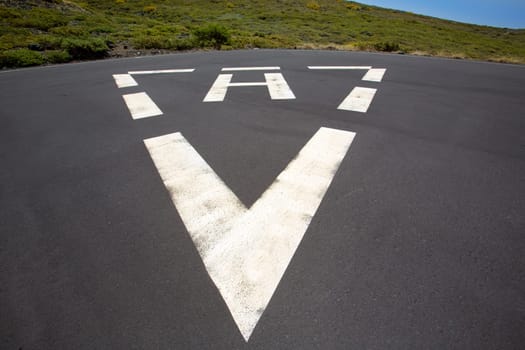 heliport triangle white soil painted sign in pavement